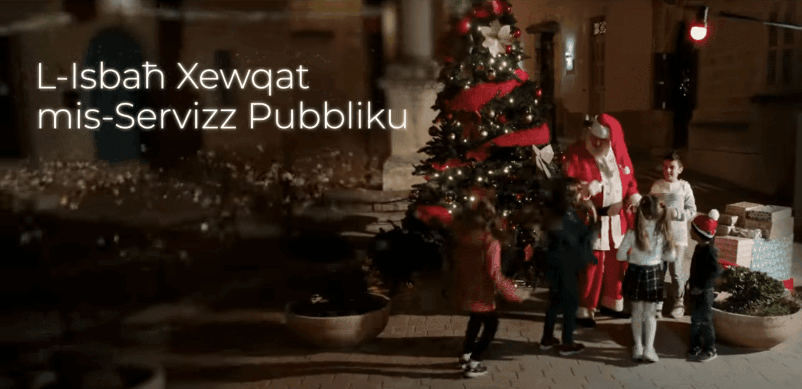Santa Claus and the kids around a Christmas Tree